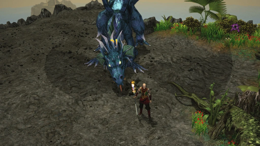 Fantastyczny smok o niebieskiej łusce oraz postać wojownika stojąca naprzeciw niego na skalistym terenie, dookoła rośnie bujna roślinność oraz kolorowe kwiaty, a w tle widoczne są skały i fragment nieba.