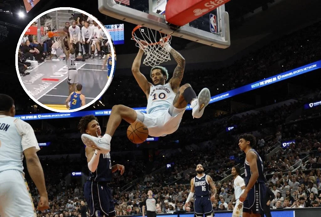 San Antonio Spurs ponownie przegrało z Golden State Warriors Koszykarz wykonuje efektowny wsad do kosza podczas meczu, zawieszając się na obręczy. Kilku innych zawodników z przeciwnej drużyny obserwuje akcję, a trybuny są pełne kibiców. W lewym górnym rogu widoczna jest powiększona wstawka z inną sytuacją boisko...