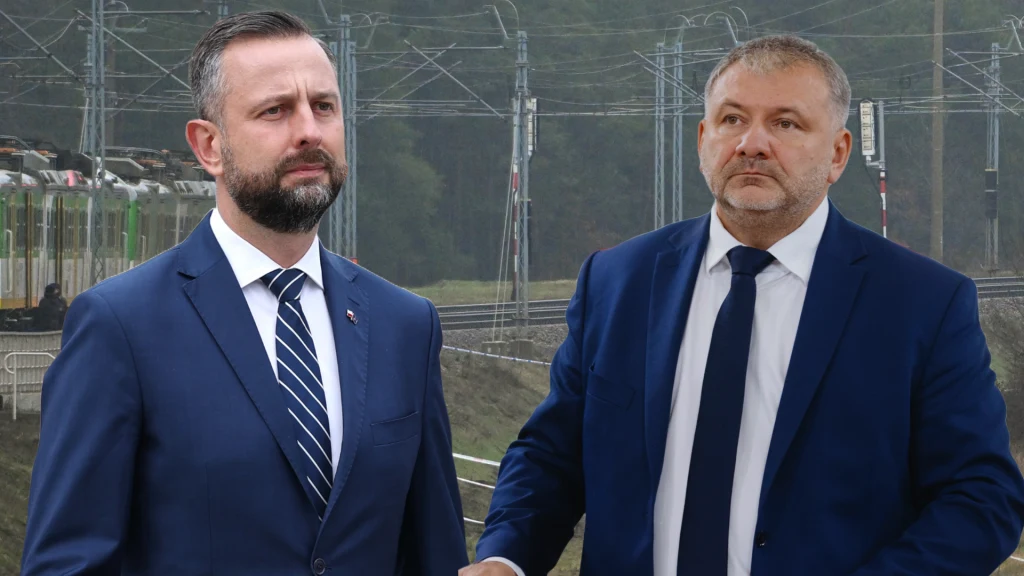 Ministrowie w ogniu pytań w związku z aktem dywersji Dwóch mężczyzn w garniturach stoi na tle infrastruktury kolejowej, za nimi widoczne są tory i słupy trakcyjne, kompozycja skupia się na postaciach ubranych formalnie.