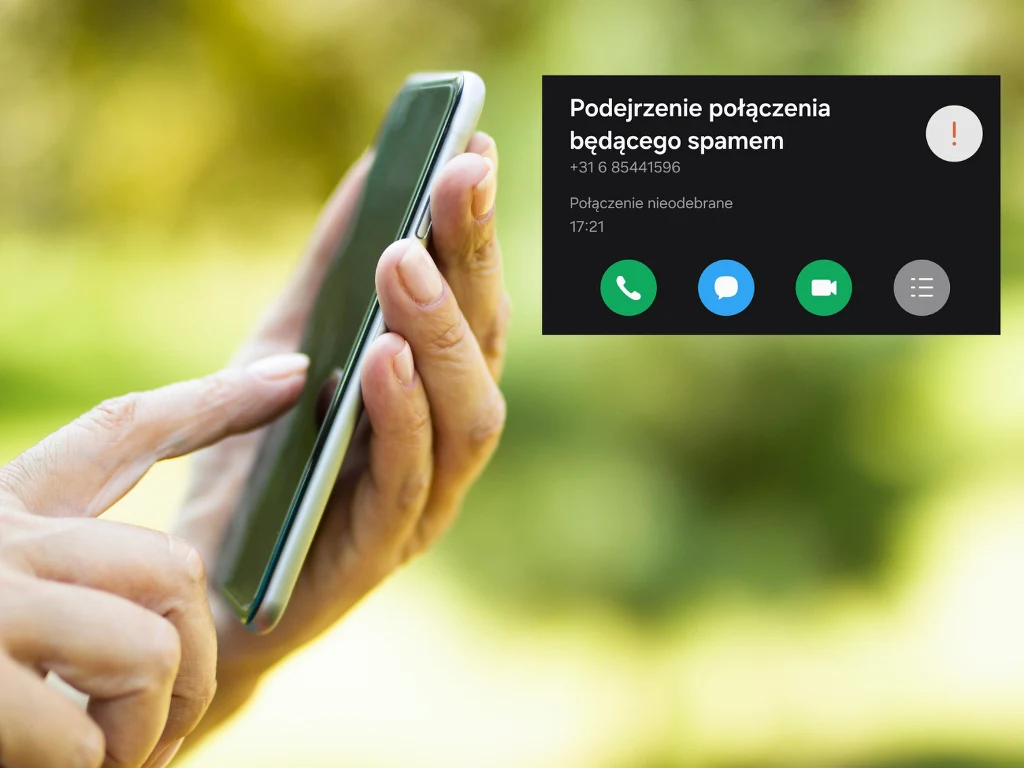 Osoba trzymająca smartfon w dłoni na tle zielonego, rozmytego otoczenia, a na ekranie telefonu powiadomienie o nieodebranym połączeniu uznanym za potencjalny spam.
