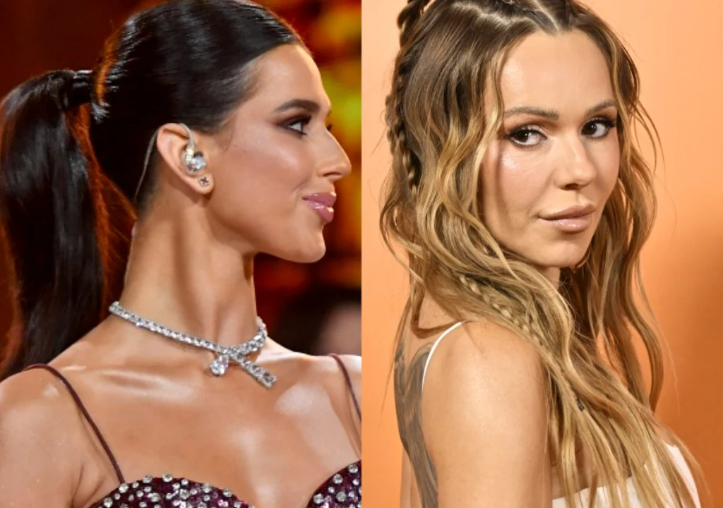 Roxie Węgiel, Doda Dwie kobiety w eleganckich stylizacjach, jedna z ciemnymi, spiętymi włosami ozdobiona naszyjnikiem i kolczykami, druga z pofalowanymi, jasnymi włosami rozpuszczonymi na tle w ciepłych odcieniach.