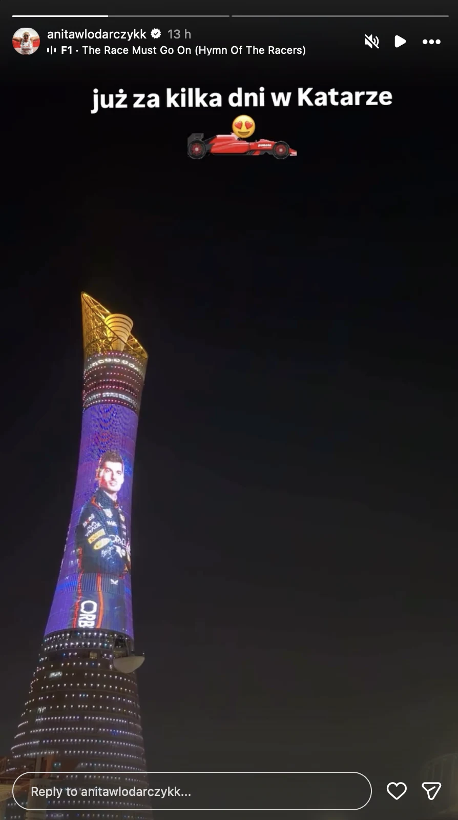 Oświetlony wieżowiec Aspire Tower w nocy, na którym wyświetlony jest portret kierowcy Formuły 1 ubranego w kombinezon wyścigowy. Nad wieżowcem znajduje się biały napis 'już za kilka dni w Katarze' oraz grafika samochodu wyścigowego z emotikonem z serce...