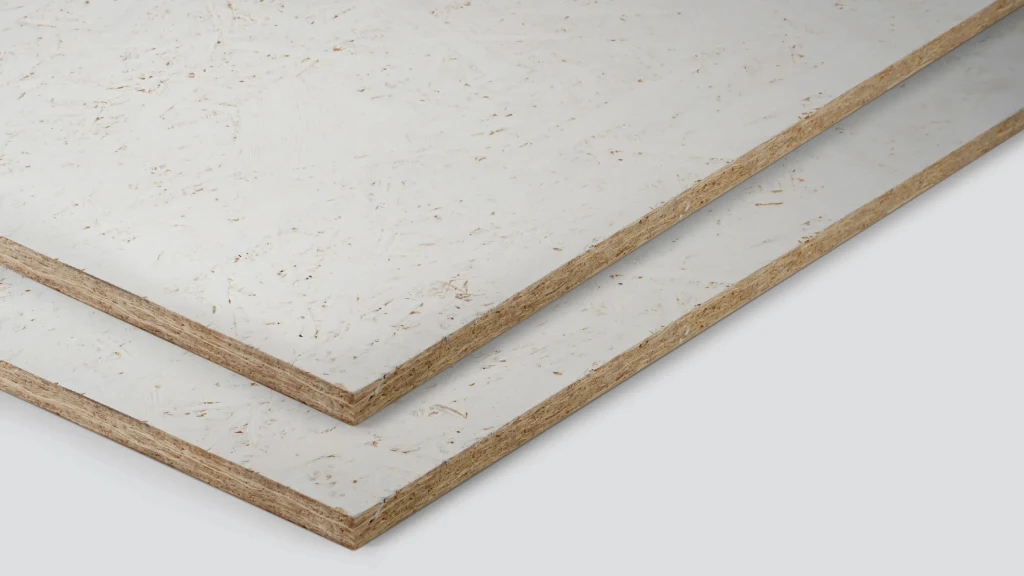 Dwie płyty wiórowe w jasnym kolorze, ustawione jedna na drugiej, widoczne zbliżenie ukazujące warstwową strukturę oraz fakturę materiału.