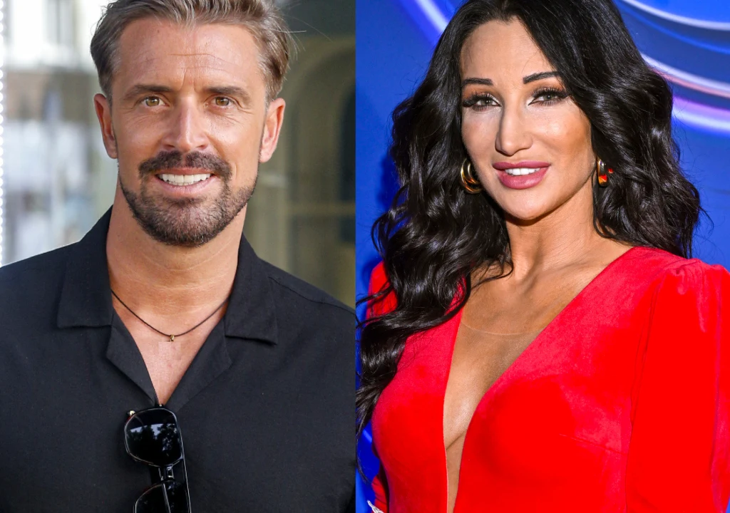 Justyna Steczkowska, Stanisław Karpiel-Bułecka Mężczyzna z zarostem, ubrany w czarną koszulę i kobieta o długich, czarnych, kręconych włosach, w czerwonej, eleganckiej sukni z głębokim dekoltem. Oboje uśmiechnięci, stojący na neutralnym tle.