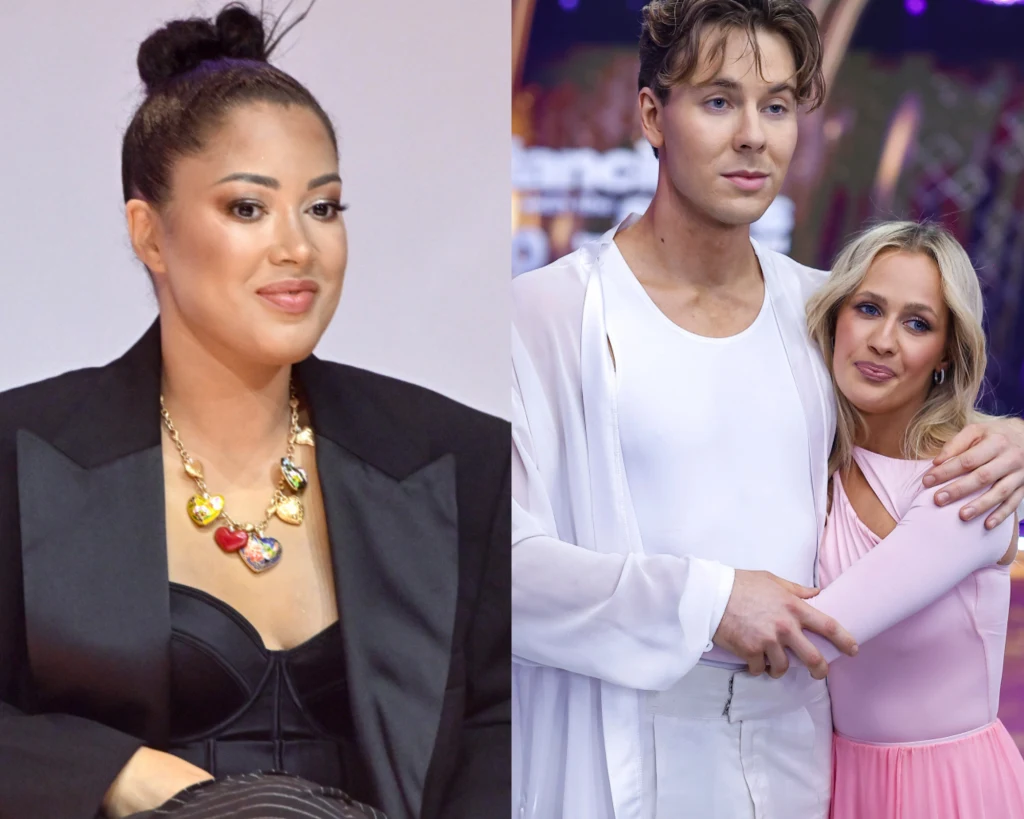 Patrycja Kazadi komentuje wygraną Bagiego w "TzG" Po lewej stronie kobieta w stylowej czarnej marynarce i kolorowym naszyjniku, po prawej młody mężczyzna w białej stylizacji i kobieta w różowej sukni obejmują się na tle jasnych świateł.