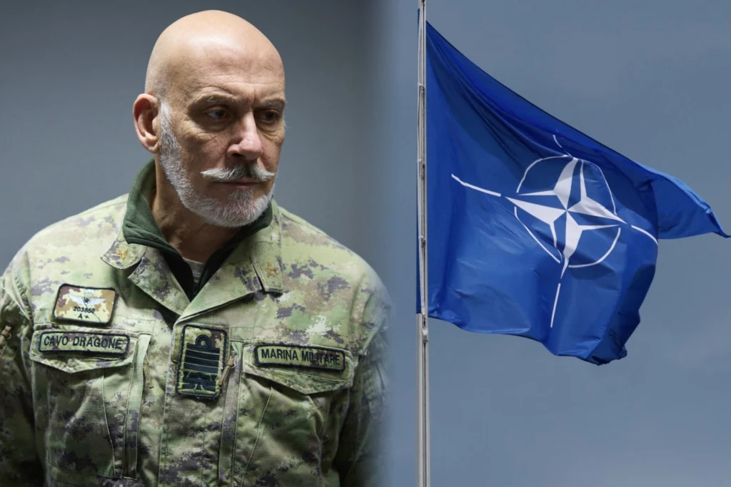 Admirał Giuseppe Cavo Dragone twierdzi, że NATO może "bardziej agresywnie" przeciwdziałać hybrydowym atakom Rosji Mężczyzna w mundurze wojskowym z wyraźnym stopniem oficerskim, obok widoczna flaga NATO na tle jasnego nieba.