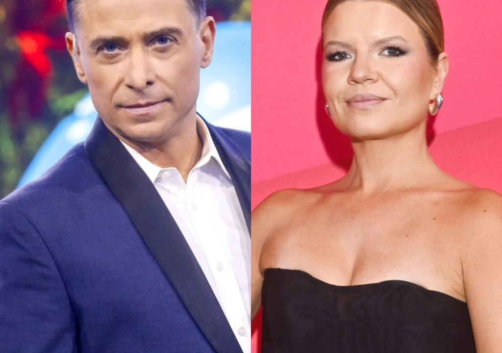 Kacper Kuszewski i Marta Manowska Dwie osoby elegancko ubrane, mężczyzna w granatowej marynarce i białej koszuli, kobieta w czarnej sukience na tle jasnoróżowego tła.