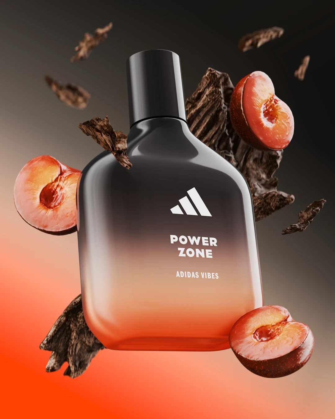 Nowoczesny flakon perfum marki Adidas otoczony połówkami śliwek i kawałkami ciemnego drewna na rozmytym tle w odcieniach czerwieni i szarości, całość tworzy dynamiczne wrażenie zapachu inspirowanego naturą.