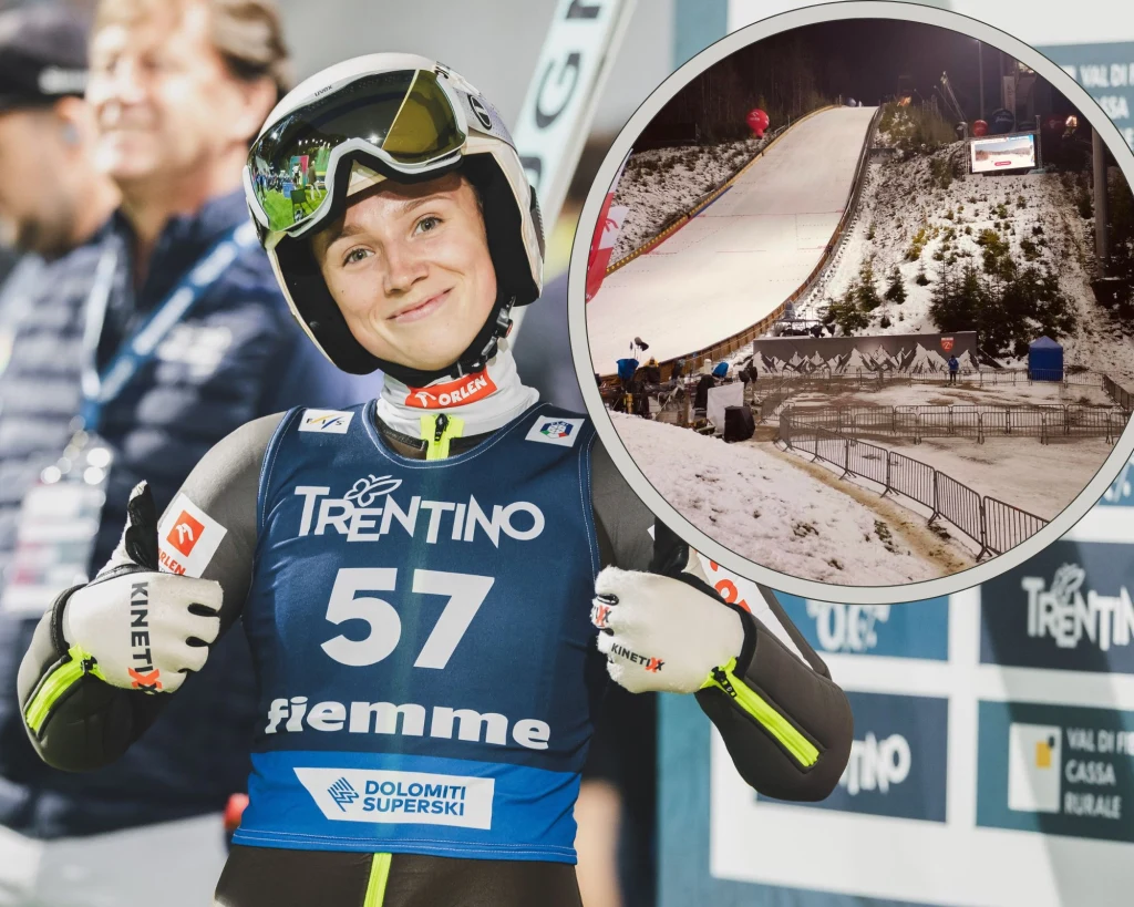 Anna Twardosz, a w ramce skocznia w Wiśle i pustki pod nią Zadowolona zawodniczka ubrana w strój narciarski i kask z numerem startowym 57, stojąca na tle banerów sponsorskich, wykonuje gest zaciśniętych kciuków. W prawym górnym rogu znajduje się okrągła wstawka ukazująca skocznię narciarską pokrytą śniegiem.