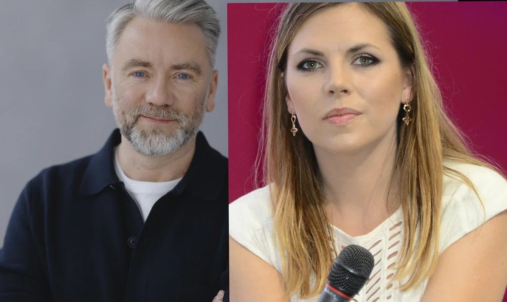 Kuba Badach i Aleksandra Kwaśniewska Mężczyzna o siwych włosach i brodzie w ciemnej koszuli obok kobiety z jasnymi włosami, trzymającej mikrofon i ubraną w białą bluzkę, oboje patrzą poważnie w stronę aparatu.