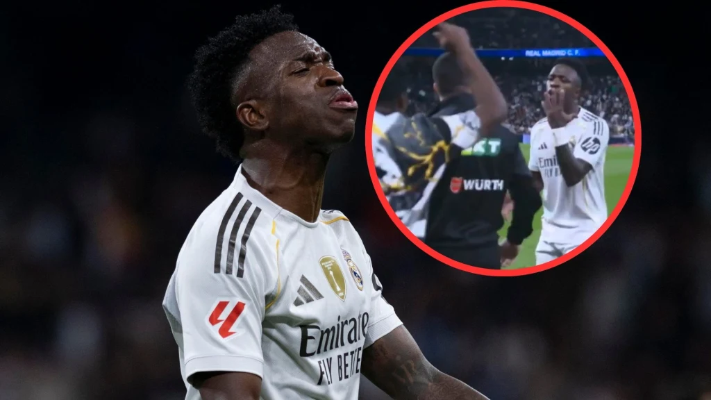 Piłkarz Realu Madryt w białym stroju z wyrazem emocji na twarzy, na tle ciemnego stadionu, w okrągłej ramce widoczna sytuacja z boiska, gdzie zawodnik wykonuje gest ręką, prawdopodobnie reagując na wydarzenia podczas meczu.