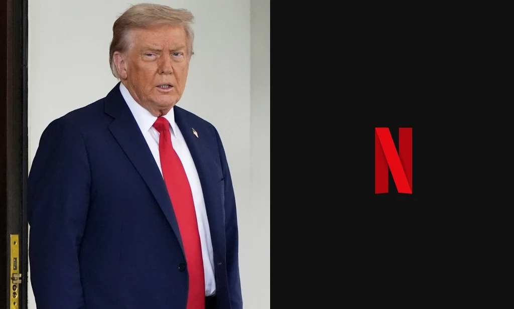 Wykup Warner Bros. Discovery przez Netflixa rodzi sporo problemów Mężczyzna w garniturze z czerwoną krawatą stoi obok czarnego tła z charakterystycznym czerwonym logotypem Netflixa.