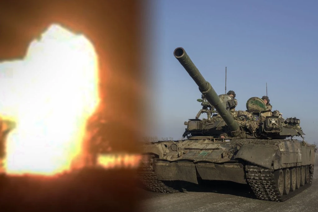 Czołg na drodze z żołnierzami na pokładzie, po lewej stronie intensywny wybuch światła i ognia, tło stanowi niebo i otwarty teren.