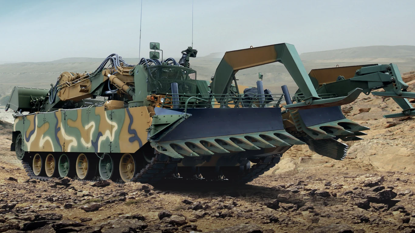 Korea Południowa zamawia kolejne czołgi saperskie. Już dwa lata temu miały być dostarczone Ukrainie Ciężki pojazd gąsienicowy w wojskowym kamuflażu wyposażony w specjalistyczny sprzęt inżynieryjny, takie jak lemiesze i hydrauliczne ramiona, porusza się po skalistym, pustynnym terenie.