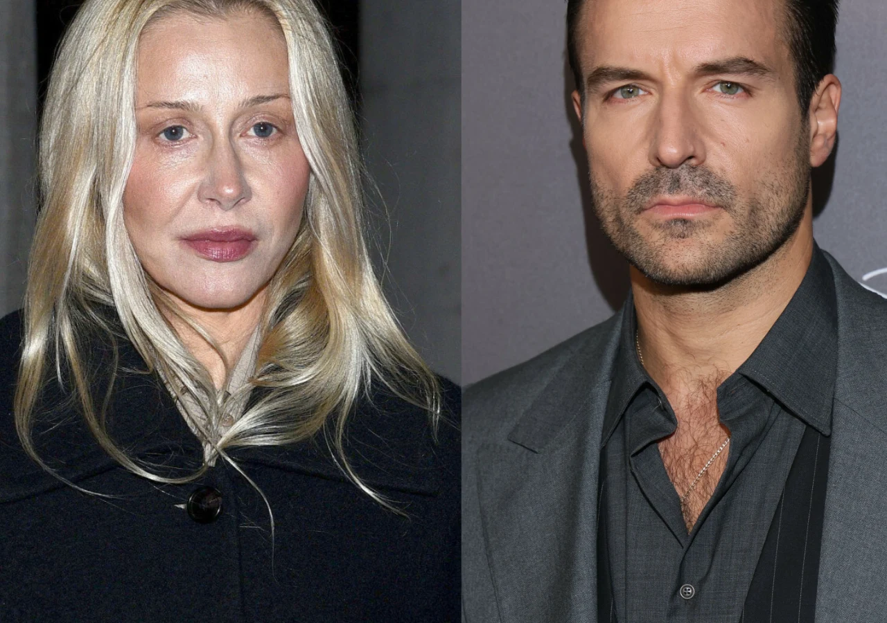 Portret kobiety o jasnych włosach ubranej w ciemny płaszcz obok mężczyzny w eleganckiej marynarce i rozpiętej koszuli, oboje patrzące bezpośrednio w obiektyw.