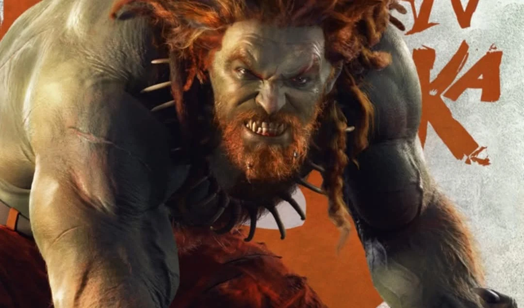 Postać o muskularnej sylwetce z pomarańczowymi dredami i brodą, z wyrazem groźnej determinacji na twarzy, pochylona w dynamicznej pozie. Skóra szarozielona, postać ubrana minimalistycznie, z akcentami przypominającymi bestię, w tle wyraźny fragment tek...