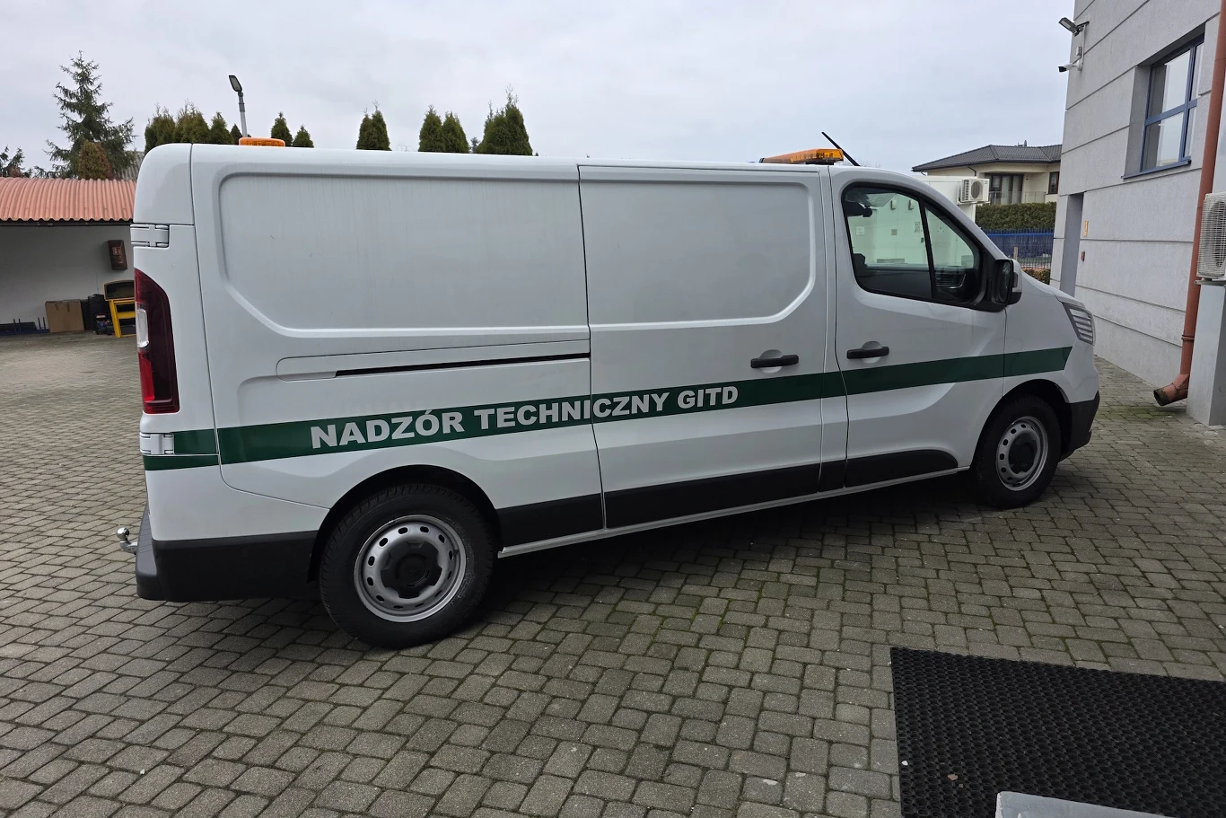 Auta będą służyły do serwisowania automatycznych systemów nadzoru ruchu Biały samochód dostawczy oznaczony napisem „NADZÓR TECHNICZNY GITD” zaparkowany na kostce brukowej obok budynku. Pojazd posiada pomarańczowe światła ostrzegawcze na dachu.