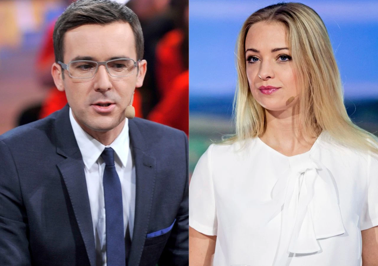 Maciej Kurzajewski i Barbara Kurdej-Szatan na planie "Kocham cię Polsko" Mężczyzna w garniturze i kobieta w białej bluzce, oboje patrzą przed siebie, tło rozmyte, scena studyjna.