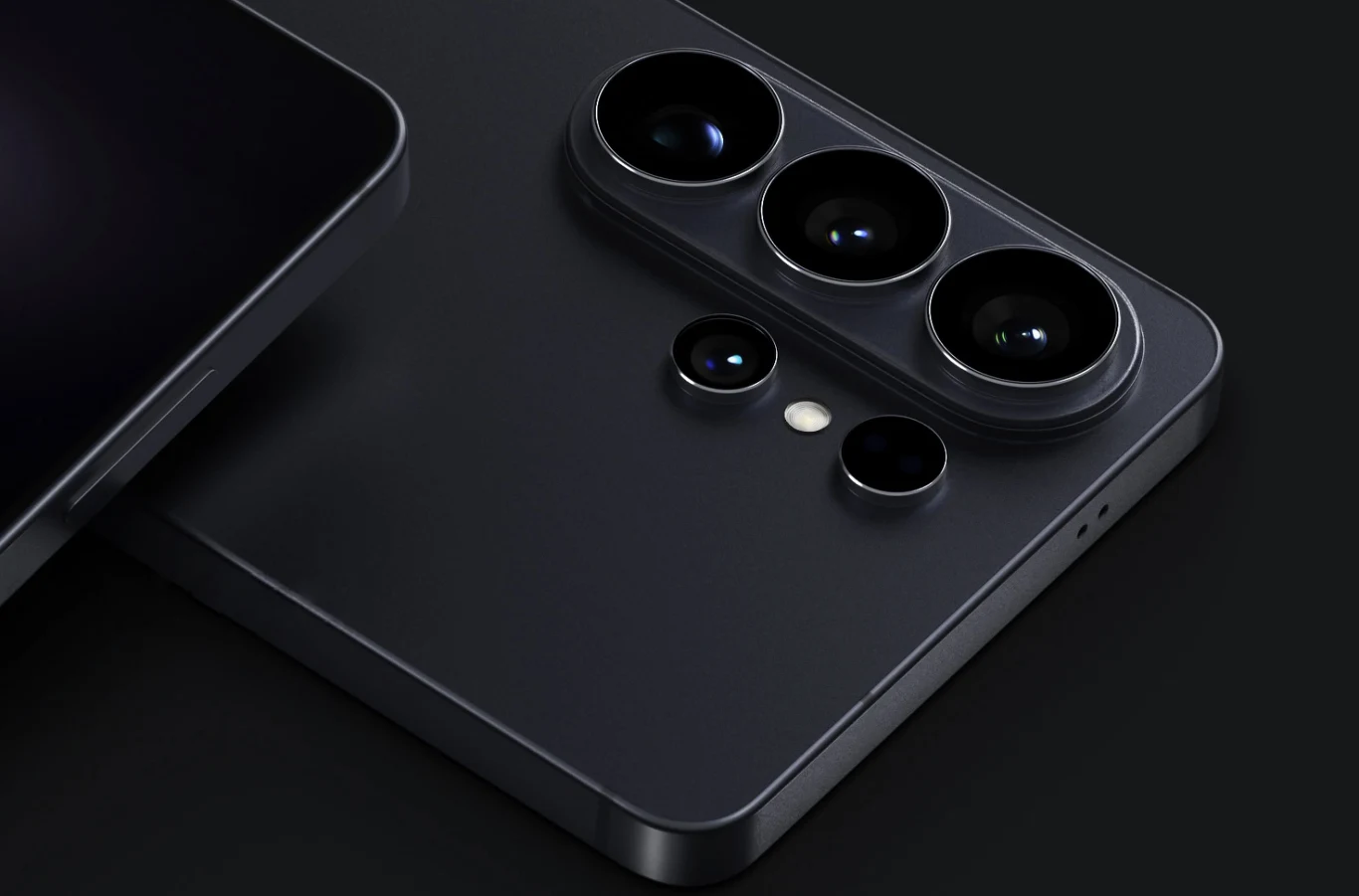 Samsung Galaxy S26. Ceny i specyfikacja. Co wiemy przed premierą? Czarny smartfon z wypukłym modułem aparatu z trzema dużymi obiektywami i jednym mniejszym oraz diodą LED na gładkim tle.