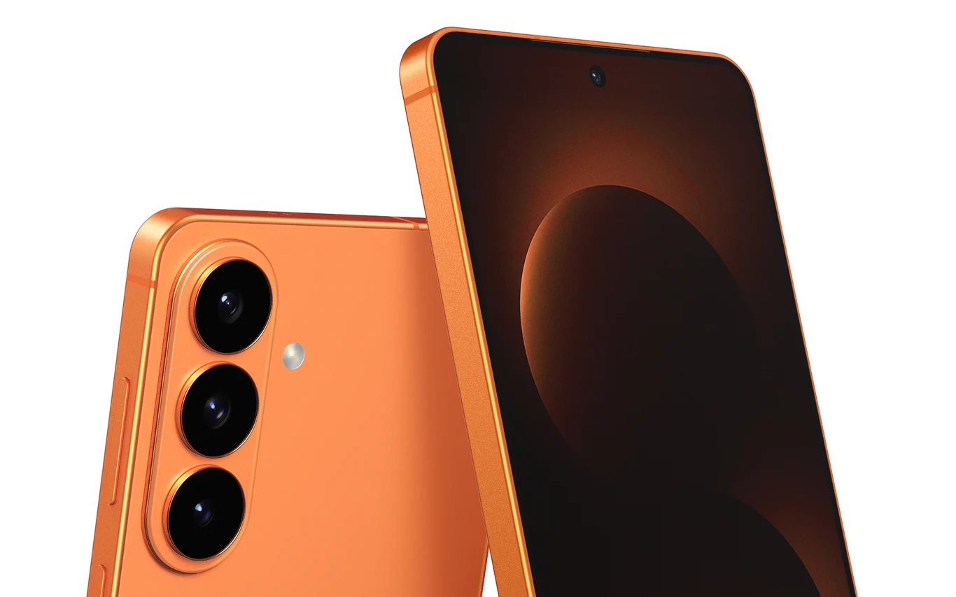 Przeprojektowany aparat fotograficzny pojawia się we wszystkich modelach Samsung Galaxy S26. Nowoczesny smartfon w pomarańczowej obudowie z trzema aparatami fotograficznymi z tyłu oraz dużym ekranem dotykowym z minimalnymi ramkami.