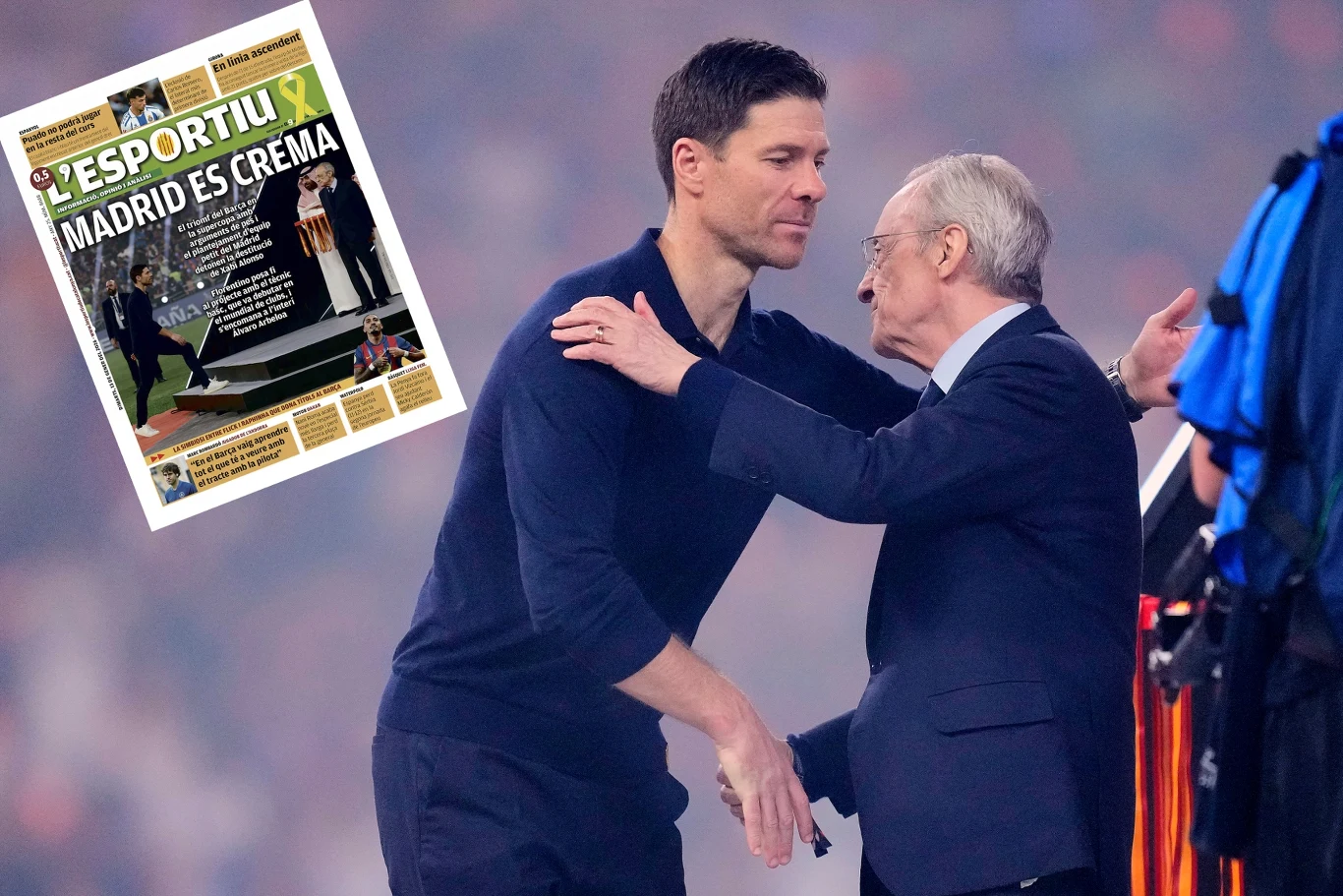 Dwóch mężczyzn w ciemnych ubraniach wymienia serdeczny uścisk na tle stadionu, z boku widoczny fragment prasy sportowej z nagłówkiem dotyczącym klubu piłkarskiego Real Madryt.