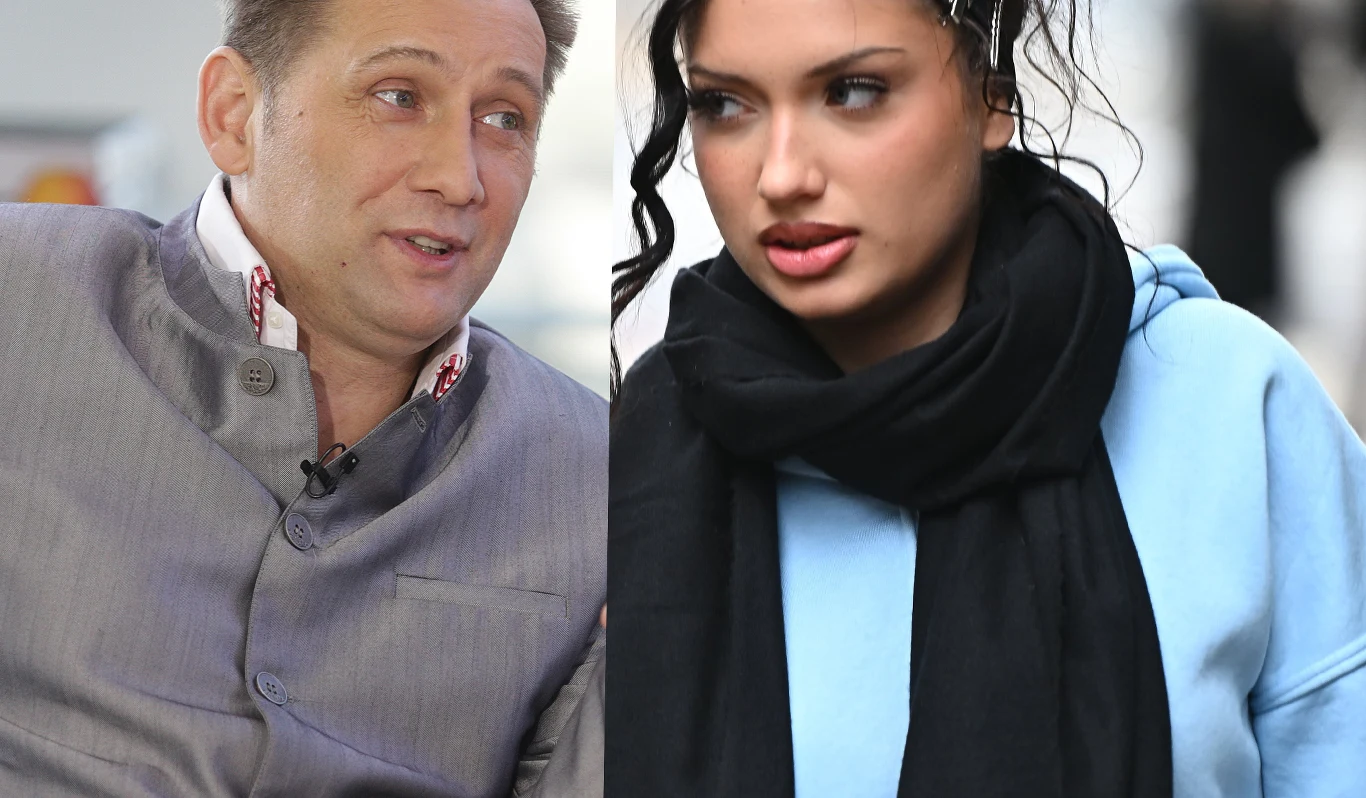 Bogdan Trojanek i Viki Gabor Mężczyzna w szarej marynarce rozmawia z kobietą w błękitnej bluzie i czarnym szaliku, oboje skupieni na rozmowie, kobieta wygląda poważnie.