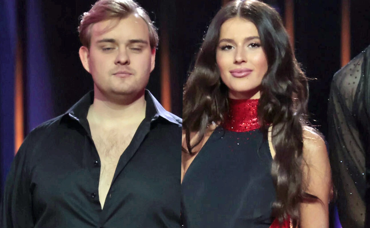 Kevin Mglej i Roxie Węgiel Dwoje młodych ludzi w eleganckich, scenicznych strojach stoi obok siebie na tle ciemnej kurtyny. Kobieta ma długie, falowane włosy i połyskującą czerwoną stójkę, mężczyzna ubrany jest w rozpiętą czarną koszulę.