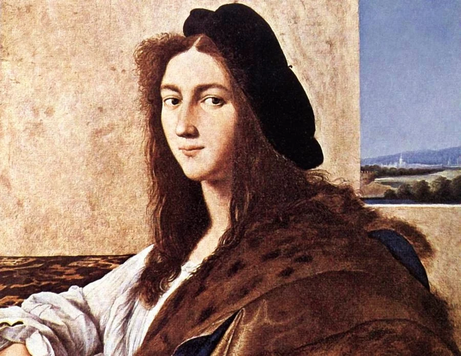 "Portret młodzieńca" Rafaela. Czy obraz z kolekcji Czartoryskich ocalał? Młody mężczyzna o długich, brązowych włosach, ubrany w białą koszulę i ciemny beret, siedzi na tle jasnej ściany z widokiem na krajobraz za oknem. Jego spojrzenie jest skierowane w stronę widza, a po lewej stronie widoczne jest futro zarzucone na ramie...