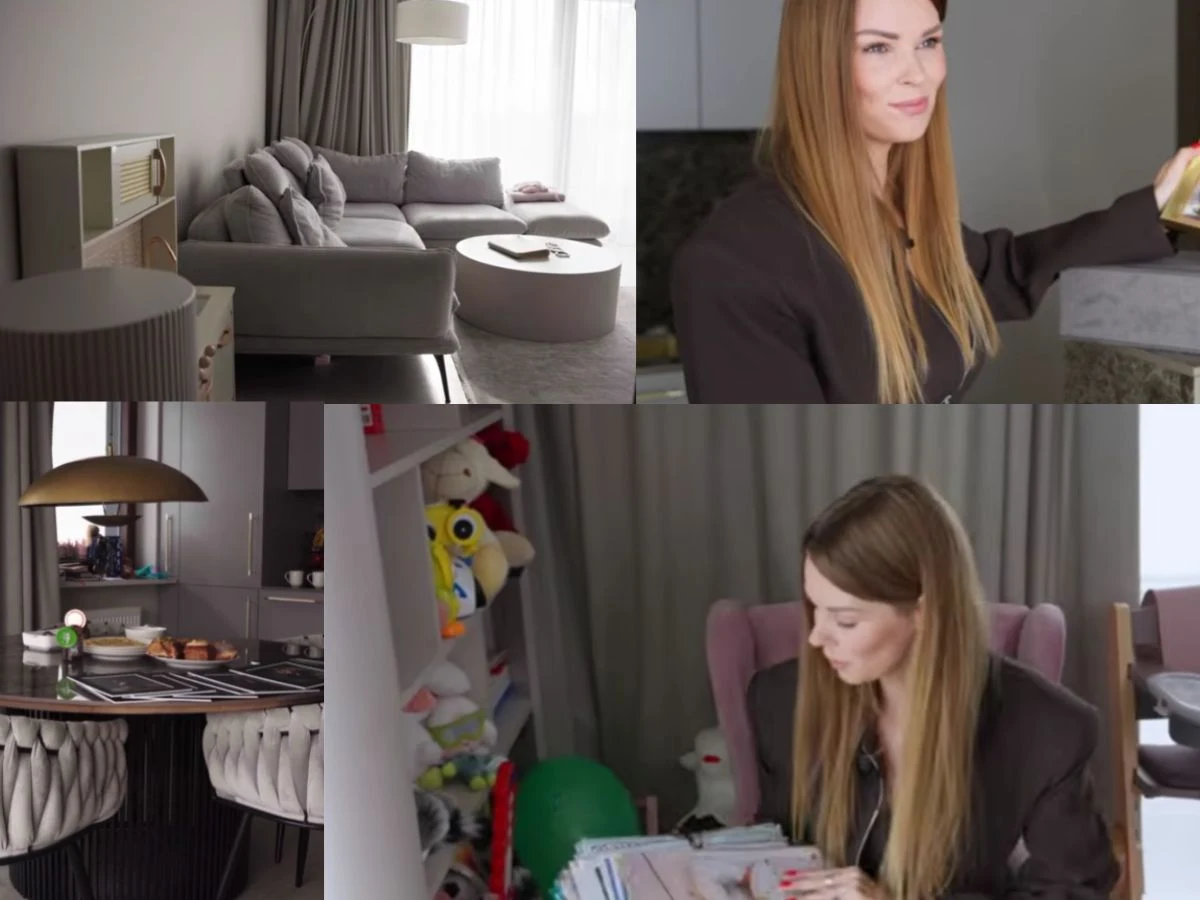 Nowoczesny salon z szarą sofą, jasnym stolikiem i dekoracjami, kobieta o długich blond włosach wykonująca różne czynności oraz kącik jadalniany z okrągłym stołem i lampą, półka z zabawkami i dokumentami.