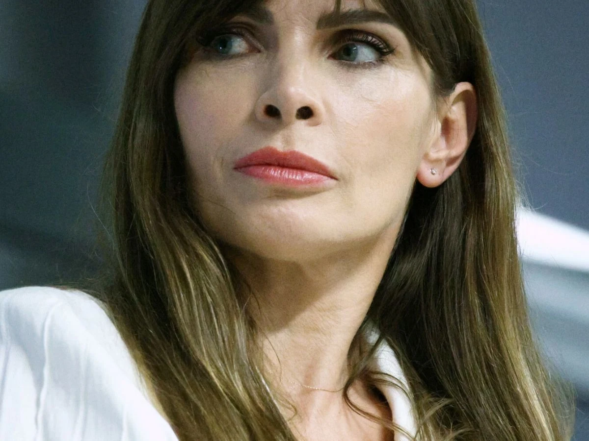 Agnieszka Dygant Agnieszka Dygant ubrana w białą koszulę, patrząca w lewo z poważnym wyrazem twarzy.