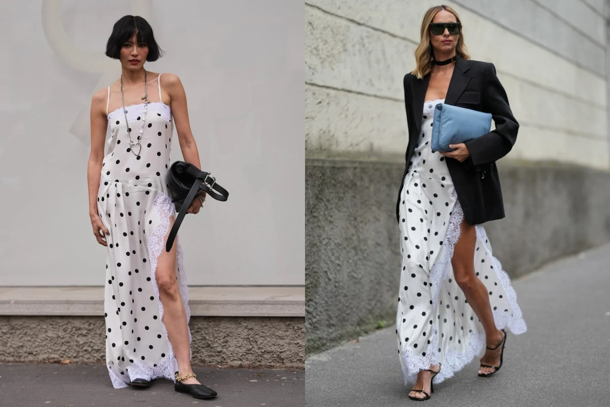 Dwie kobiety ubrane w białe sukienki w czarne grochy z wysokim rozporkiem oraz koronkowym wykończeniem – jedna z nich nosi czarne mokasyny i trzyma czarną torebkę, druga ma na sobie czarne sandały na obcasie, czarną marynarkę, okulary przeciwsłoneczne ...