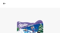 Zestaw świąteczny Milka/Oreo 182 g w ozdobnym opakowaniu z zimową grafiką, wyeksponowany z wyraźną informacją o promocji cenowej 0,99 zł na żółto-czerwonym tle, poniżej szczegóły lokalizacji sklepu przy ul. Warszawskiej 42 w Warszawie.