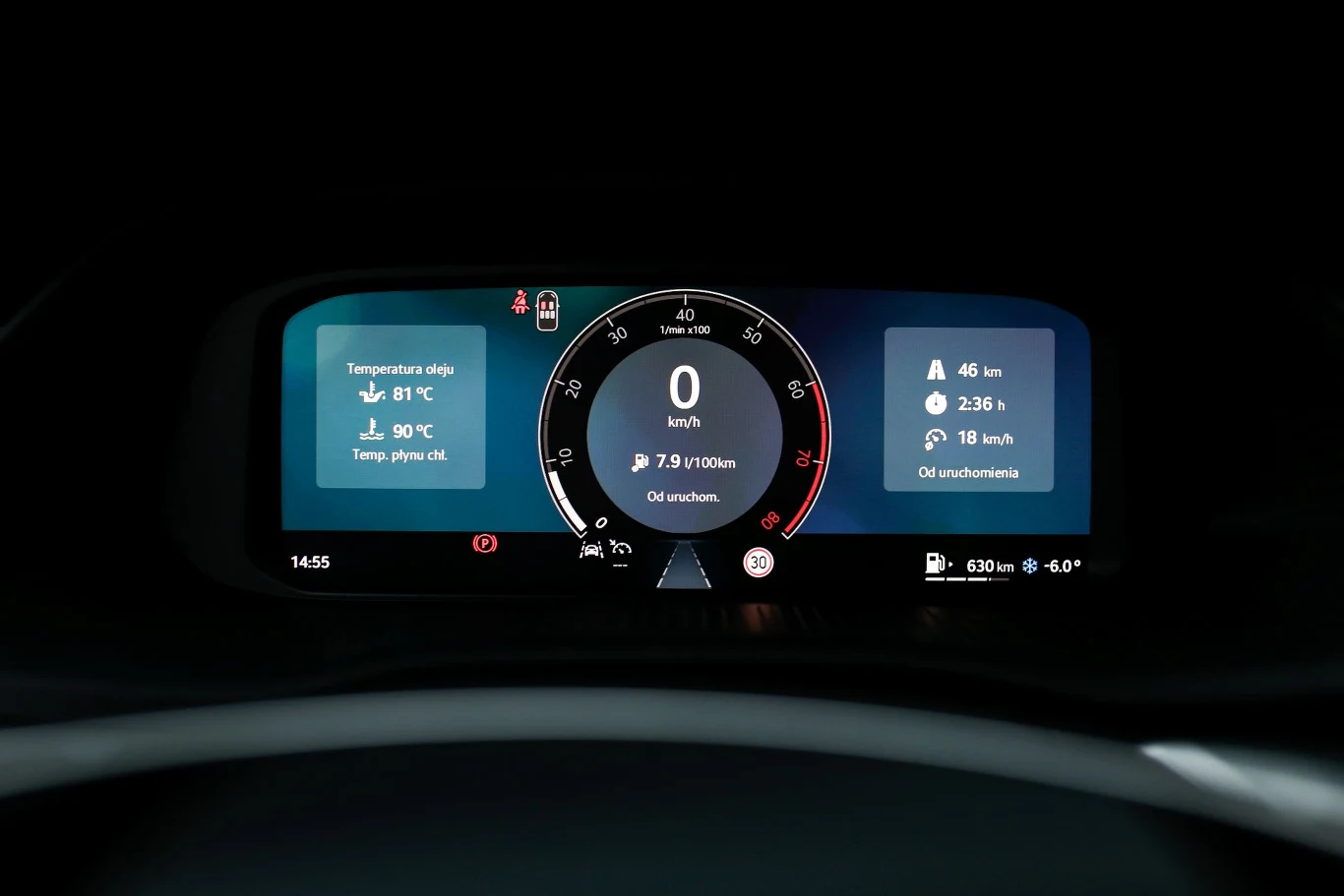 Cyfrowy wyświetlacz samochodowy z centralnym prędkościomierzem, wskaźnikiem zużycia paliwa oraz informacjami o temperaturze silnika i płynu chłodniczego, czasem jazdy, przebiegu oraz poziomie paliwa.