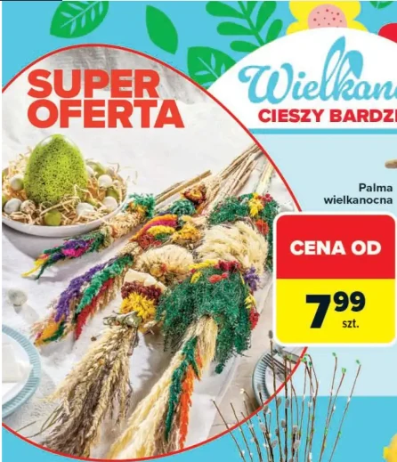 Tradycyjne palmy wielkanocne wykonane z suszonych traw i barwionych roślin ułożone na białym obrusie obok dekoracji z zielonej mchy i pisanek; wyróżniona cena 7,99 zł oraz hasło promocji na tle kolorowej, świątecznej grafiki.
