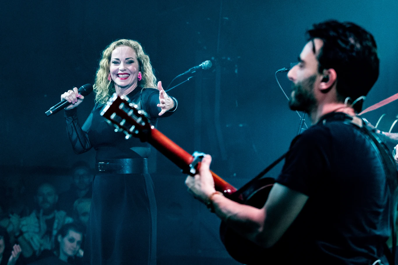 Anneke van Giersbergen przyjedzie do Polski z solowym materiałem Anneke van Giersbergen śpiewa do mikrofonu, obok gitarzysta gra na gitarze akustycznej.