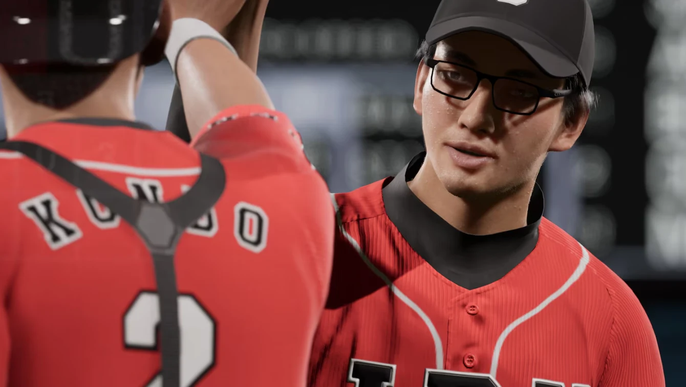 Dwóch bejsbolistów w czerwonych strojach zespołu LBU przybija sobie „piątkę”; jeden z nich nosi okulary i czarną czapkę, drugi ma na plecach napis KONDO i numer 2.