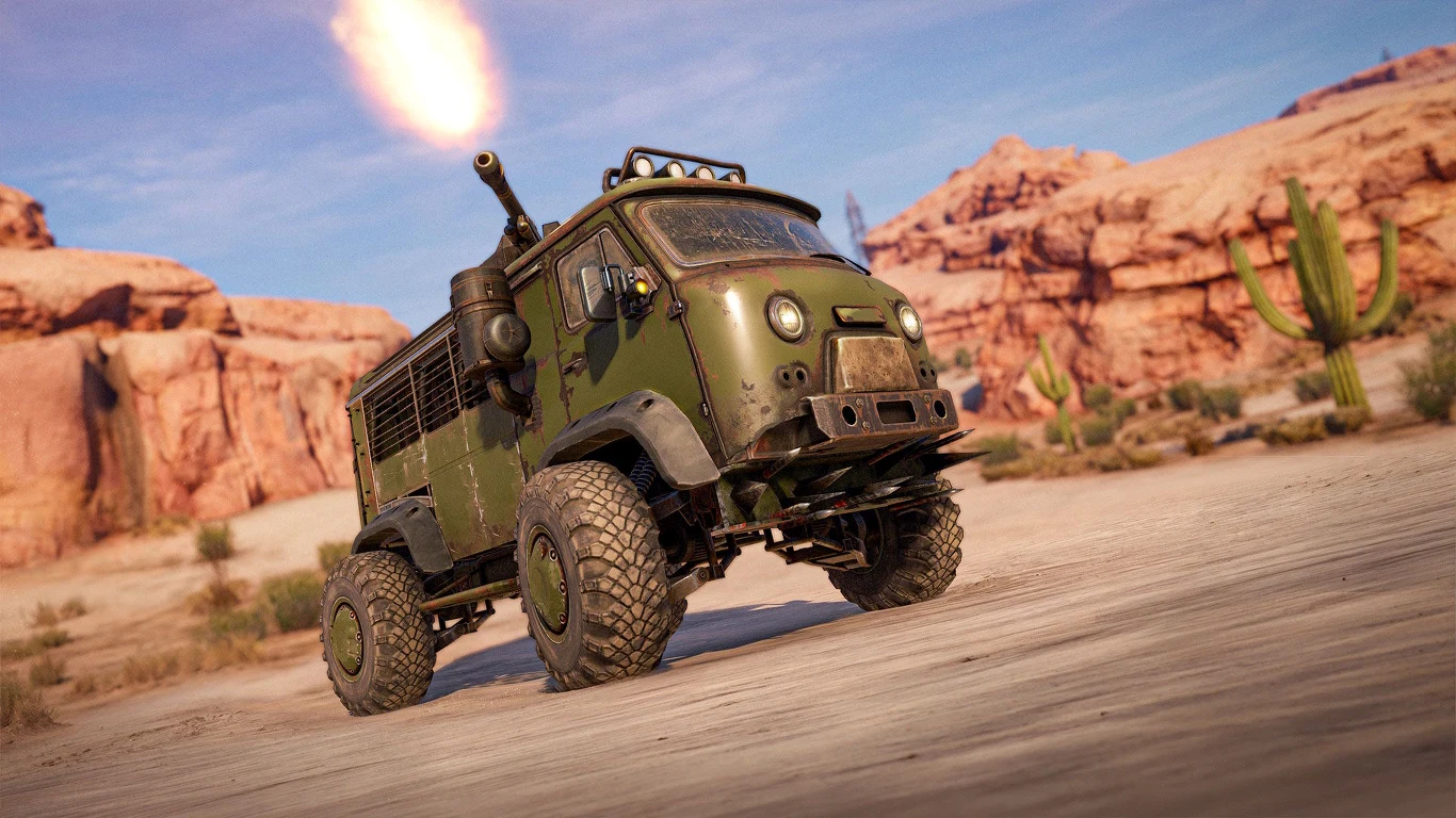 zielony pojazd terenowy z zamontowaną na dachu artylerią oddającą strzał na pustynnym, skalistym terenie pośród kaktusów i formacji skalnych