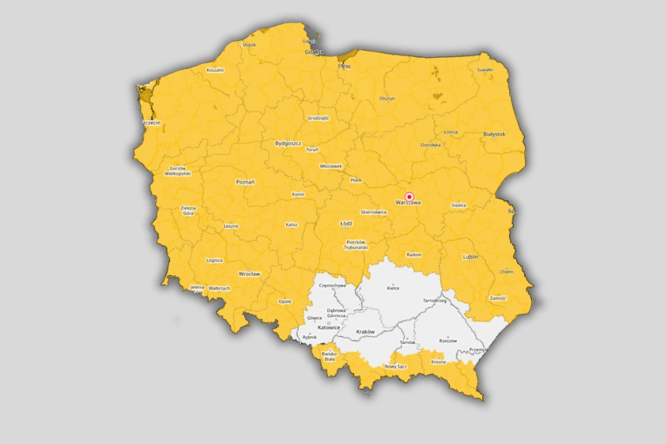 Mapa Polski z zaznaczonymi województwami, gdzie większość kraju jest pokryta żółtym kolorem, a południowe regiony są oznaczone kolorem białym; widoczna jest granica między regionami oraz lokalizacja Warszawy oznaczona czerwonym punktem.