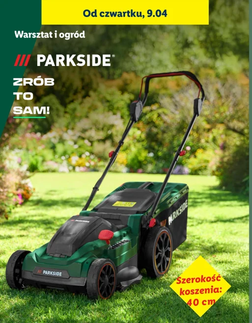 zielona kosiarka elektryczna Parkside z dużym koszem na trawę ustawiona na trawniku w ogrodzie, dobrze widoczny napis z informacją o szerokości koszenia 40 cm