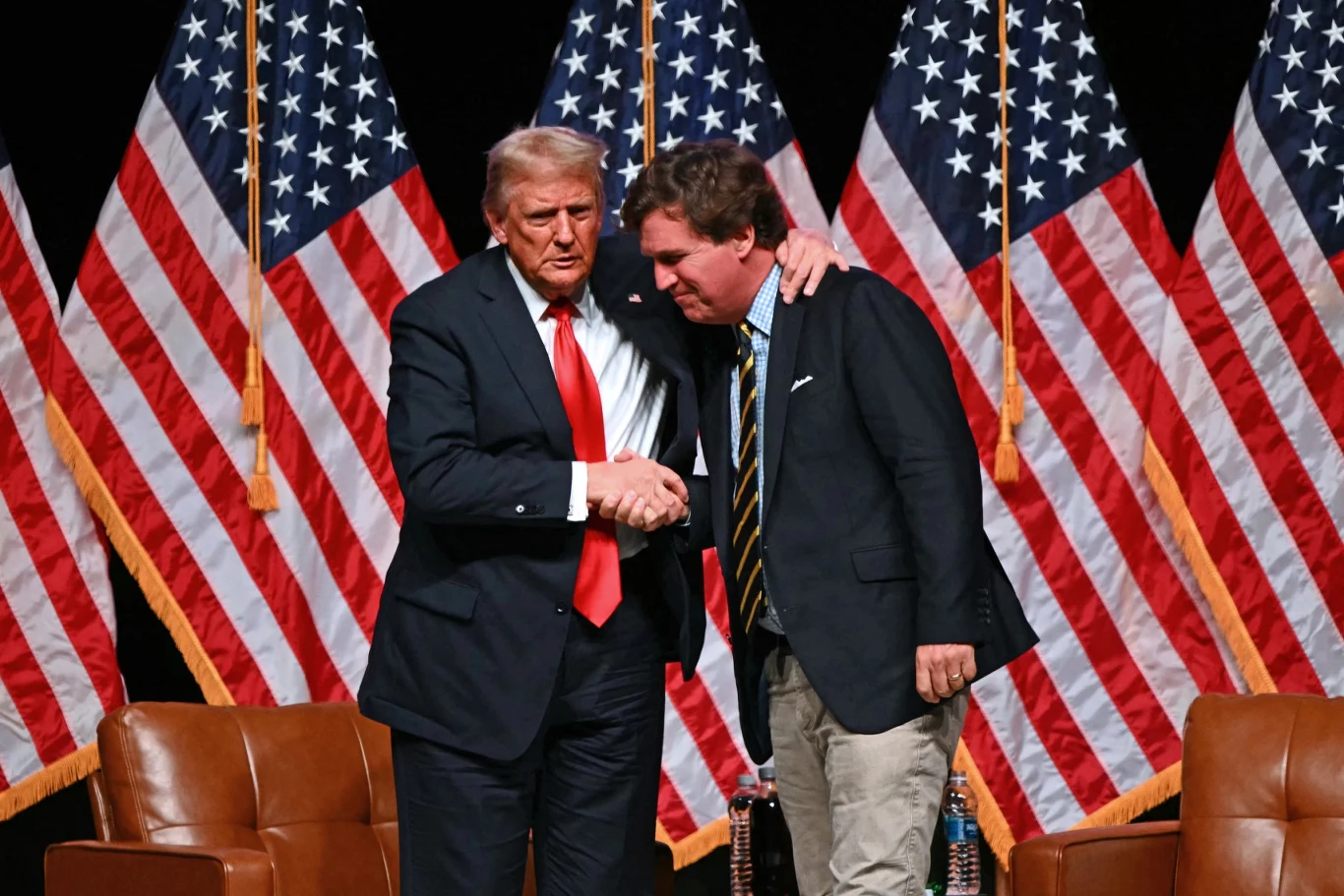 Donald Trump i Tucker Carlson Donald Trump i Tucker Carlson na tle amerykańskich flag.