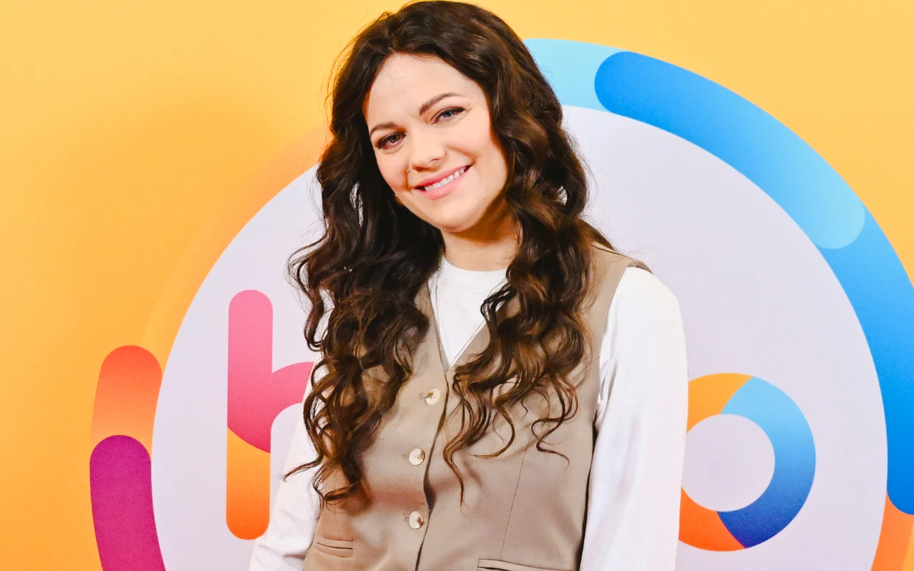 drka Paulina Ihnatowicz Doktorka Paulina Ihnatowicz w beżowej kamizelce i białej koszuli, stojąca na tle kolorowego logotypu "halo tu polsat".