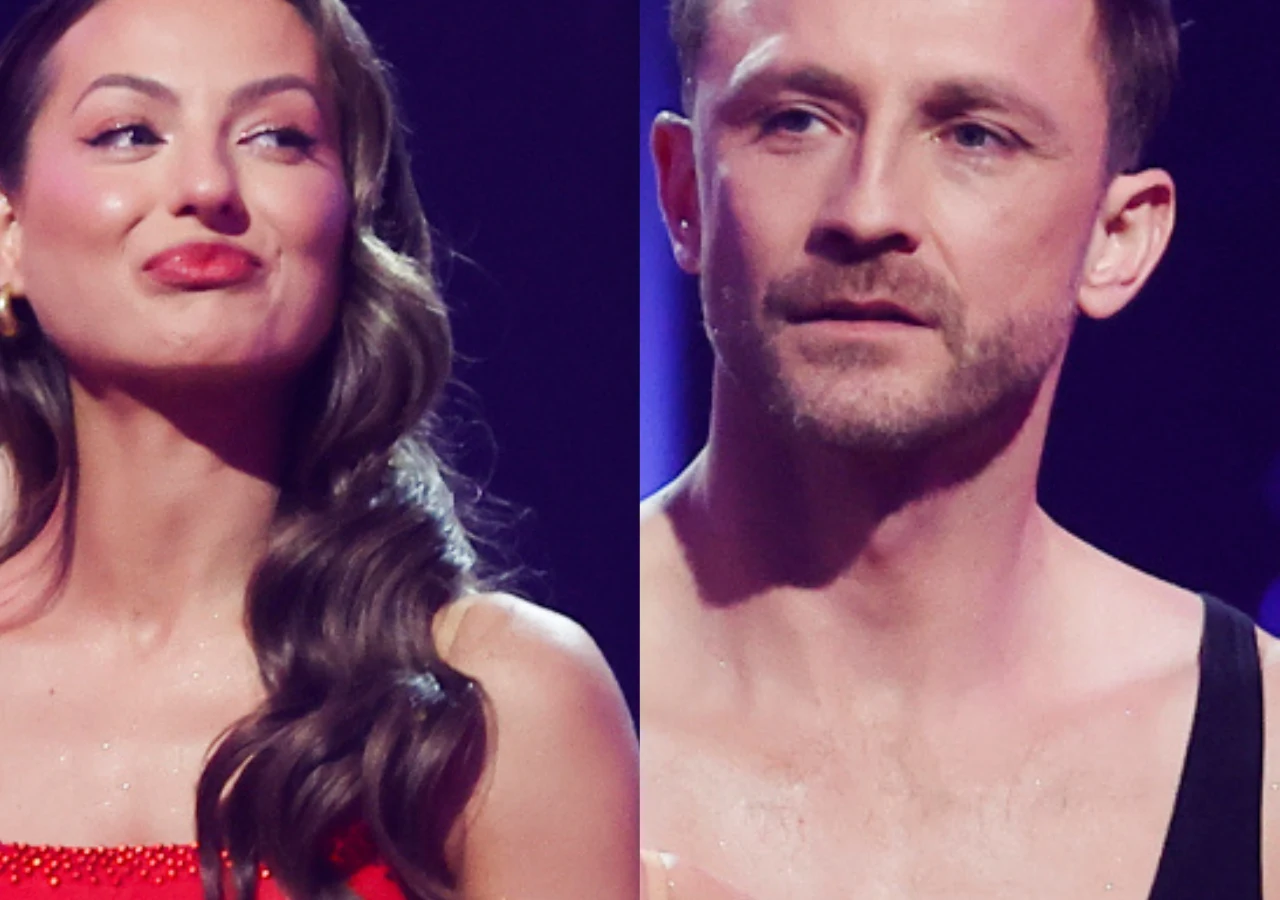 Izabela Skierska, Kamil Nożyński Izabela Skierska w czerwonej sukience i Kamil Nożyński w czarnym stroju stoją obok siebie.