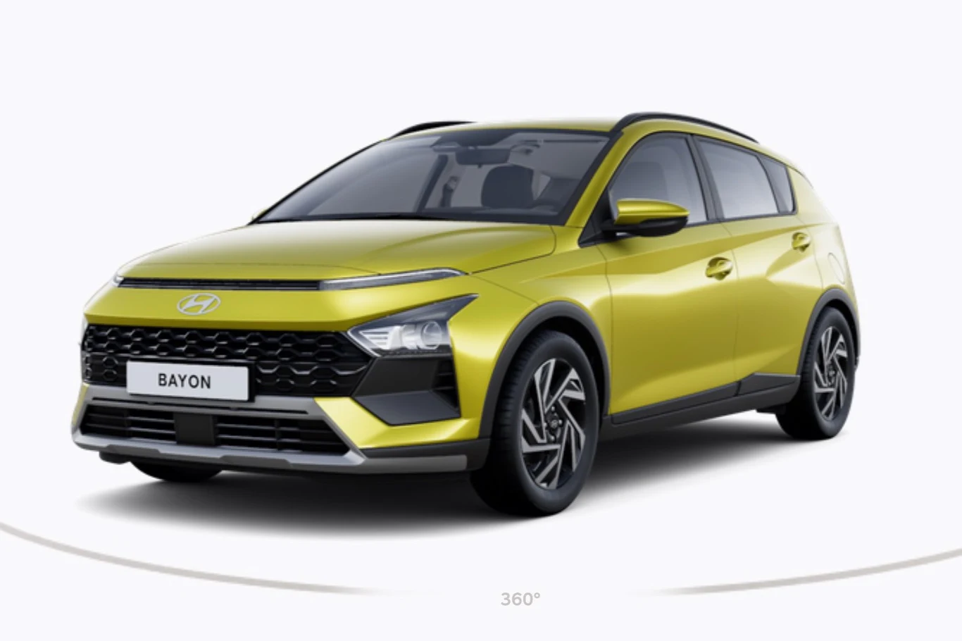 jasnozielony samochód typu SUV marki Hyundai Bayon z nowoczesnym designem, czarnymi akcentami przy nadkolach i na dachu oraz pięcioramiennymi felgami