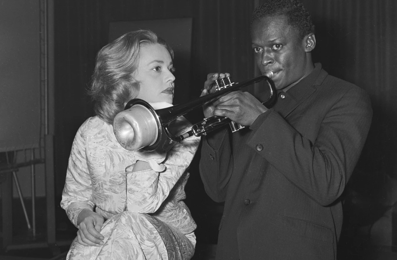 Jeanne Moreau i Miles Davis podczas promocji filmu "Windą na szafot" w Paryżu (1957) Miles Davis gra na trąbce obok siedzącej Jeanne Moreau podczas promocji filmu "Windą na szafot" w 1957 roku.