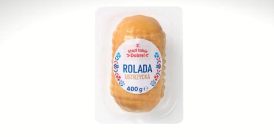 opakowanie rolady ustrzyckiej o wadze 400 g w przezroczystym plastikowym pojemniku z widoczną etykietą zawierającą nazwę produktu oraz pastelowe zdobienia na tle białym