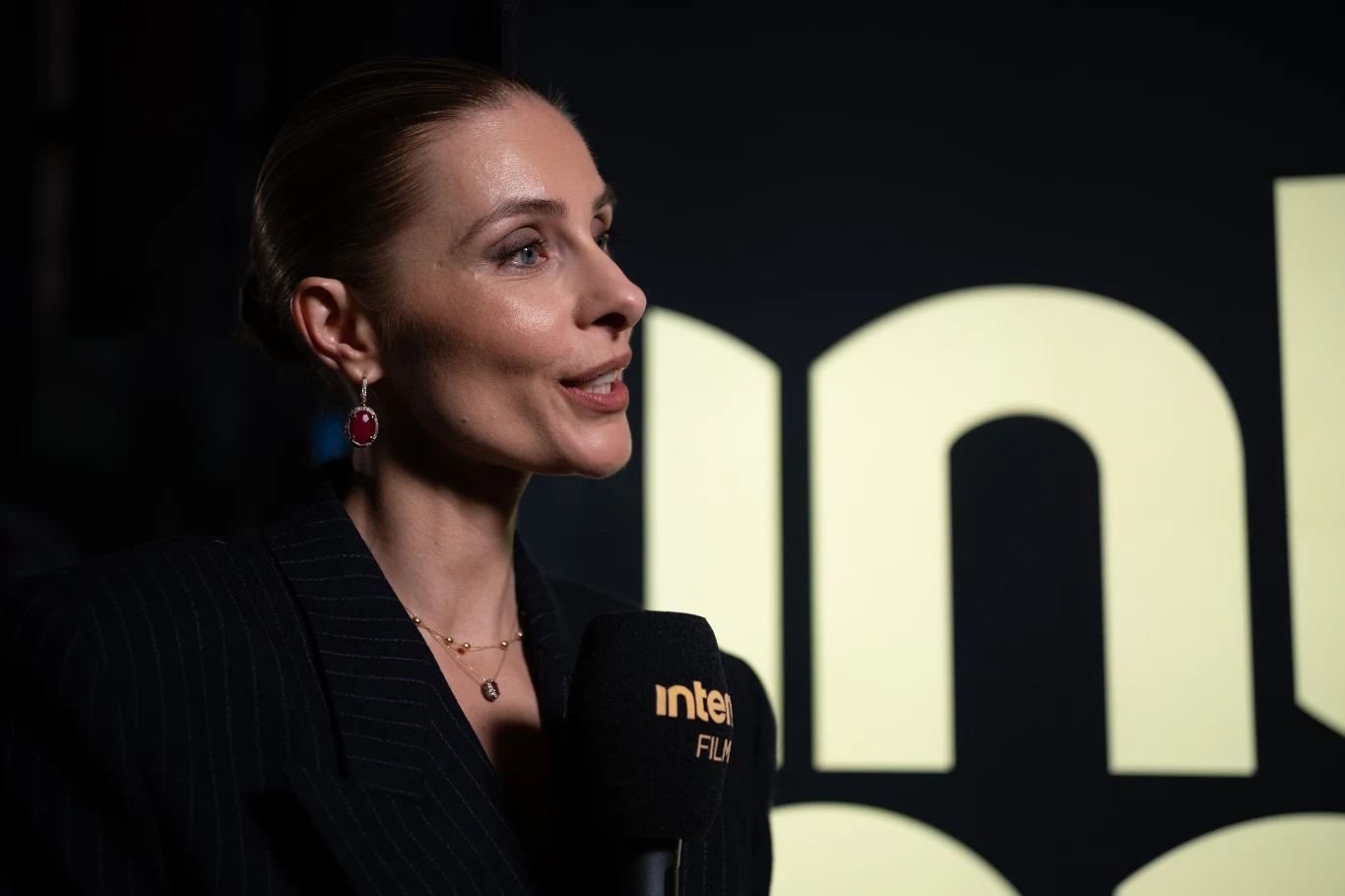 Katarzyna Zawadzka podczas gali otwarcia 19. edycji festiwalu Mastercard OFF Camera Katarzyna Zawadzka podczas wywiadu na gali otwarcia Mastercard OFF Camera, mikrofon z logo interia, ciemny strój