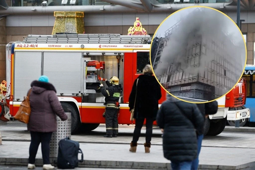 Pożar na budowie w Moskwie Pożar na budowie w Moskwie; strażacy przy wozie, dym unosi się wokół wielopiętrowego budynku.