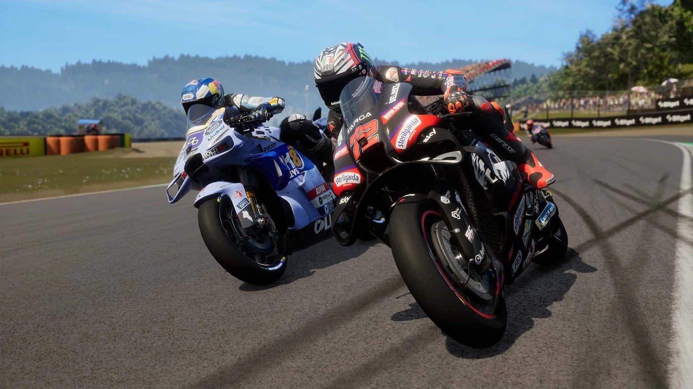 MotoGP 26 MotoGP 26 – dwaj motocykliści na torze, jeden na czarno-czerwonym, drugi na biało-niebieskim motocyklu.