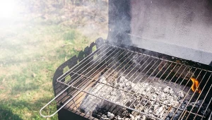 Grill with burning coals ready for barbecue outdoors