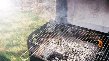 Grill with burning coals ready for barbecue outdoors